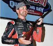  ?? [AP PHOTO] ?? FORT WORTH, TEXAS — Kurt Busch shows off the shotgun he received Friday as a trophy for winning the pole for the O’Reilly Auto Parts 500 at Texas Motor Speedway, which will run at 1 p.m. Sunday.