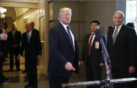  ?? JACQUELYN MARTIN — THE ASSOCIATED PRESS ?? President Donald Trump answers a question from the press about discussion of the tax bill, Thursday on Capitol Hill in Washington. Trump is at the Capitol for a pep rally with House Republican­s, shortly before the chamber is expected to approve the tax...