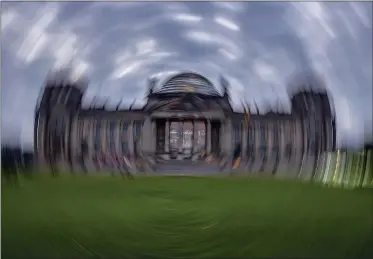  ?? MICHAEL PROBST—ASSOCIATED PRESS ?? Picture taken while turning the camera shows the Reichstag building with the German parliament in Berlin, Germany, Sunday, Sept. 26, 2021. German elections are held on Sunday.