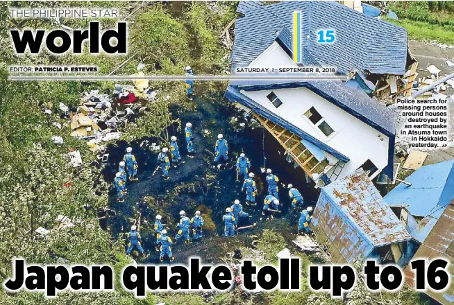  ?? AP ?? Police search for missing persons around houses destroyed by an earthquake in Atsuma town in Hokkaido yesterday.