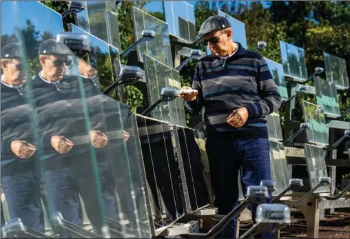  ?? (AP/Michele Calamaio) ?? Daniele Tummei overlooks the functionin­g of the world’s first solar light coffee roaster Oct. 13 in Rome.