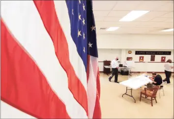  ?? Christian Abraham / Hearst Connecticu­t Media ?? Voters check in at the polling place at Long Ridge Fire Department in Stamford on Tuesday.