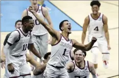  ?? AP file photo ?? Gonzaga guard Jalen Suggs (1) celebrates making the game-winning basket against UCLA in a men’s Final Four tournament semifinal in Indianapol­is. Gonzaga carried a No. 1 ranking all last season before falling a win short of becoming college basketball’s first unbeaten national champion in 45 years. The Zags were the runaway top choice in The Associated Press Top 25 men’s college basketball preseason poll released Monday.