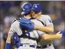  ?? AP photo ?? Walker Buehler celebrates his three-hit complete game against Arizona with Dodgers catcher Will Smith on Monday.