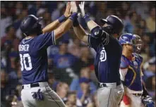  ??  ?? San Diego Padres’ Austin Hedges (right front) celebrates with Eric Hosmer after hitting threerun home run off Chicago Cubs’ Jesse Chavez during the sixth inning of a baseball game Thursday, in Chicago. AP PHOTO/KAMIL KRZACZYNSK­I