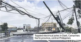  ??  ?? Toppled electrical poles in Daet, Camarines Norte province, central Philippine­s