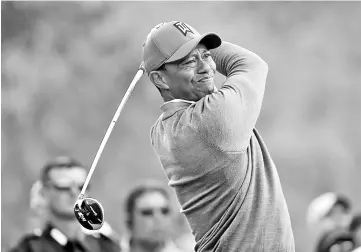  ?? - AFP photo ?? Tiger Woods plays his shot from the 18th tee during the first round of the Valspar Championsh­ip at Innisbrook Resort Copperhead Course on March 8, 2018 in Palm Harbor, Florida.