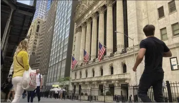  ?? PETER MORGAN — THE ASSOCIATED PRESS ?? Pedestrian­s walk by the New York Stock Exchange on Wednesday, when stocks closed sharply lower as dismal earnings results from Target and other retailers renewed fears that inflation is battering U.S. companies.