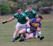  ??  ?? Paudie McGing comes under pressure from Alan Tutty and Harry Mangan of Donard-The Glen.