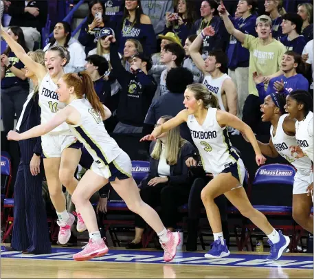  ?? PHOTO BY MARK STOCKWELL — BOSTON HERALD ?? The Foxboro girls empty the bench as the game ends with them defeating Norwell during the MIAA Div. 3 state championsh­ip basketball game in Lowell.