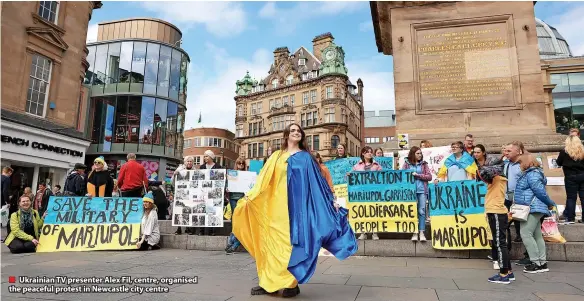  ?? ?? ■ Ukrainian TV presenter Alex Fil, centre, organised the peaceful protest in Newcastle city centre