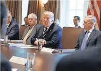  ?? EVAN VUCCI, AP ?? President Trump meets with members of his Cabinet. The president said he aims for a short-term health care “fix” this year and a major overhaul next year.