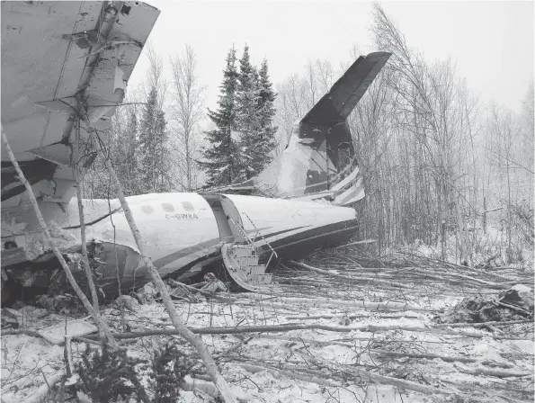  ??  ?? Wreckage of the ATR 42 operated by West Wind Aviation sits in the bush not far from the runway at the Fond du Lac airport. The plane crashed Wednesday night with 25 people on board. No one was killed but several people suffered injuries. West Wind has...