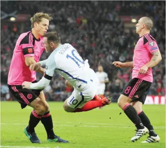  ??  ?? LONDON: England’s striker Wayne Rooney (C) collides with Scotland’s defender Christophe Berra (L) during a World Cup 2018 qualificat­ion match between England and Scotland at Wembley stadium in London on Friday. —AFP