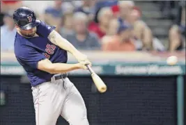  ?? Tony Dejak / Associated Press ?? The Red Sox’s Sam Travis hits a two-run double in the seventh inning against Cleveland on Friday. He also hit his first major league homer.