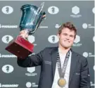  ??  ?? Magnus Carlsen, Norwegian chess grandmaste­r and current World Chess Champion with his trophy. — AFP