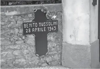  ?? [WIKIMEDIA] ?? A cross marks the place in Mezzegra where Mussolini was shot.