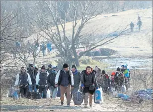  ??  ?? EXODUS: Migrants from Syria, Iraq and Afghanista­n march from Macedonia to a camp on the border of Serbia.