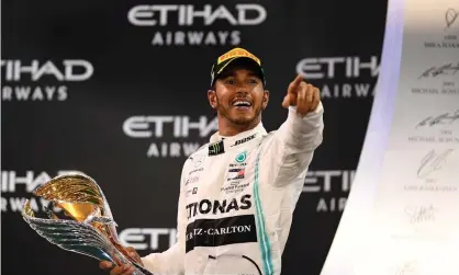  ??  ?? Abu Dhabi winner Lewis Hamilton celebrates on the podium after dominating at Yas Marina Circuit. Photograph: Clive Mason/Getty Images