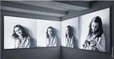  ??  ?? Photos of Anne Frank are seen at Anne Frank House museum in Amsterdam, Netherland­s.