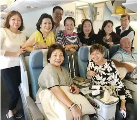  ??  ?? FLYING PAL. Onboard PAL’s B777 to Vancouver, seated from left: Marget Villarica, Rosie and Boboy Mancao. Standing are Gwen Po, Aida Uy, Alan Carvajal, Elena Young, Baby Dy, Nelia and Julius Neri.