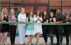  ??  ?? Alayne Curtiss (center with scissors) during a ribbon cutting ceremony for the new Make Me Fabulous.