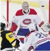  ??  ?? Canadiens goaltender Carey Price keeps an eye on a shot by Penguins centre Sidney Crosby.