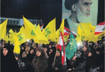  ?? Reuters ?? Supporters of Hezbollah listen to a speech by Hassan Nasrallah in Beirut this month