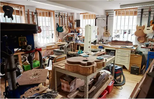  ??  ?? 1 1. The workshop walls are lined with guitars in various stages of completion, the dreams and imaginings of Tom’s customer base – note supersized SG-shaped instrument, top right