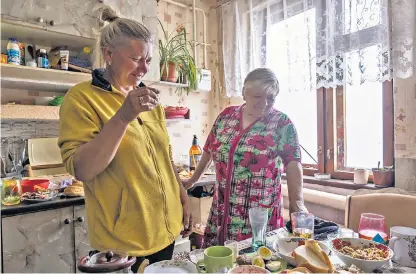  ?? ?? Clockwise from top: Valentina, 68, shelters from the bombardmen­t in the basement of her wrecked apartment block near Mykolaiv’s docks; residents queue for water after bombs hit main pipes; inside Oksana Kushnir’s home on May Day