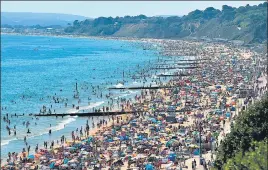  ?? AFP ?? People crowd Bournemout­h beach in England on Thursday, sparking concerns of a fresh outbreak.