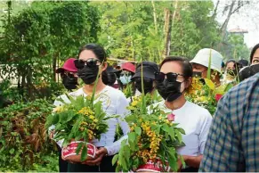  ?? — Reuters ?? No festivitie­s: People marching with Thingyan pots of ‘padauk’ flowers as they protest against the military coup in Dawei.