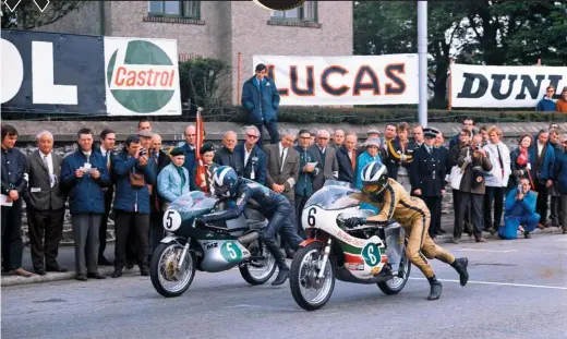  ??  ?? Above: A seasoned competitor on the IOM, here Williams (5) pushes off his works 250cc MZ next to Phil Read’s Yamaha at the 1971 Lightweigh­t TT