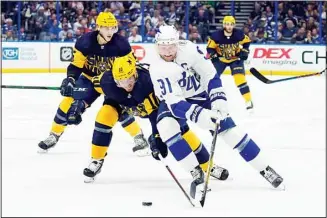  ?? ?? Tampa Bay Lightning center Steven Stamkos (91) gets around Nashville Predators center Colton Sissons (10) during the second period of an NHL hockey game, on April 23, in Tampa, Fla. Trailing the play is Nashville’s Matt Benning (5). (AP)