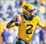  ?? WILLIAM WOTRING/AP ?? West Virginia quarterbac­k Jarret Doege makes a pass against Kansas State on Saturday.