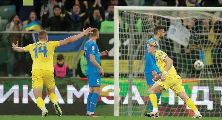  ?? — Reuters ?? Ukraine’s Mykhailo Mudryk celebrates scoring their second goal with Volodymyr Brazhko in the Euro 2024 Qualifier Play-off against Iceland at Stadion Miejski Wroclaw, Wroclaw, Poland.