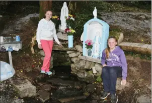  ??  ?? Lisa O’Donoghue and Heather O’Connor pictured beside the newly refurbishe­d holy well.