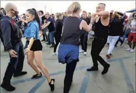  ?? Daniel Hernandez Los Angeles Times ?? PEOPLE dance to bachata in a scene that started small in the pier’s parking lot.