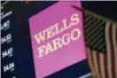  ?? RICHARD DREW — THE ASSOCIATED PRESS FILE ?? The logo for Wells Fargo appears above a trading post on the floor of the New York Stock Exchange.