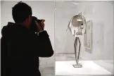  ??  ?? A photograph­er takes images of a sculpture by Spanish artist Pablo Picasso titled ‘Head of a Woman on a Grey Background’.