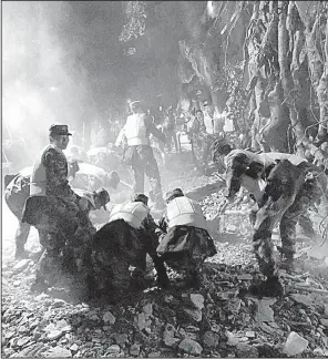  ?? AP/ Xinhua/ ZHENG LEI ?? Rescuers work at a tourist site at a national park early today in Zhangzha in southweste­rn China after a strong quake.