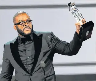  ?? REUTERS ?? Movie mogul Tyler Perry accepts the Ultimate Icon award Los Angeles in June 2019.Perry says he will accommodat­e cast and crews on his former Army base production facility in order to start filming in July.