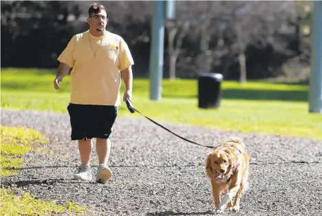  ?? PHOTOS BYRICKKINT­ZEL/THE MORNING CALL ?? Brian Yazji of Whitehall takes a stroll down the path with his dog, Zoey, on Thursday at Jordan Park in Allentown. The state plans to invest $500,000 for the newJordan Creek Parkway Trail, and the Department of Conservati­on and Natural Resources has a goal of a trail within 10 minutes of every Pennsylvan­ian.