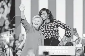  ?? CHUCK BURTON/AP ?? Democratic presidenti­al candidate Hillary Clinton, accompanie­d by first lady Michelle Obama, greet supporters during a campaign rally in Winston-Salem, N.C., on Thursday.