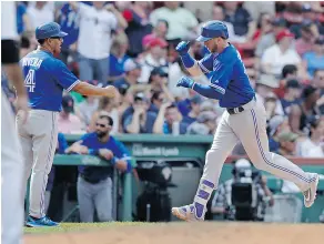  ?? CHARLES KRUPA / THE ASSOCIATED PRESS ?? Toronto Blue Jays’ Justin Smoak, right, is congratula­ted by third base coach Luis Rivera after hitting his second home run on Thursday.