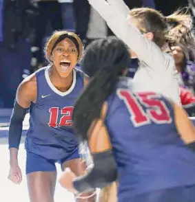  ?? Jason Fochtman/Staff photograph­er ?? Tompkins outside hitter Cindy Tchouangwa, left, reacts after scoring a point in the first set of the Falcons’ Region III-6A championsh­ip win over Cinco Ranch.
