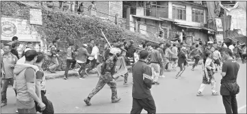  ?? — AFP photo ?? File photo shows Indian police baton-charge supporters of the Gorkha Janmukti Morcha (GJM) during a protest amid a general strike called by the GJM in Darjeeling.