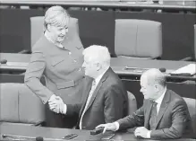  ?? MICHAEL SOHN THE ASSOCIATED PRESS ?? German Chancellor Angela Merkel, left, shakes hands with German Interior Minister Horst Seehofer, prior to a budget debate Sept. 12.