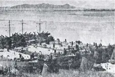  ??  ?? Though indistinct, this photo taken about 1942 shows landing barges at Kissing Point, now the site of the Rock Pool, with naval vessels moored in Cleveland Bay visible in the rear. (H.J. Taylor, The History of Townsville Harbour 1864-1979.)