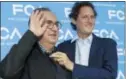  ?? THE ASSOCIATED PRESS ?? In this June 1, photo, John Elkann, president of the FCA Italy group, right, holds a necktie to Fiat Chrysler CEO Sergio Marchionne prior to a press conference at FCA headquarte­rs in Balocco, Italy.